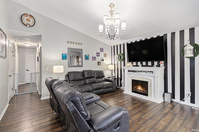 living room featuring vaulted ceiling, wood finished floors, a chandelier, baseboards, and a premium fireplace