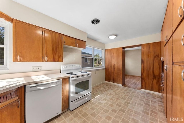221 S Ironwood Dr, South Bend, IN 46615 - kitchen featuring white appliances, brown cabinetry, light flooring, light countertops, and baseboards