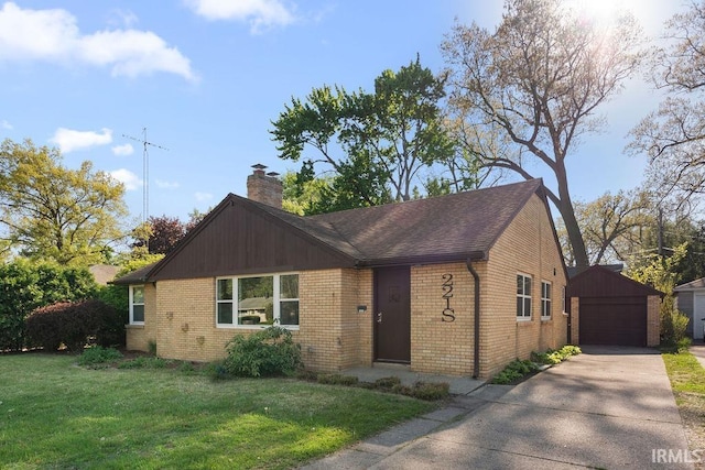 221 S Ironwood Dr, South Bend, IN 46615 - view of front of house with brick siding, a detached garage, an outdoor structure, a chimney, and a front yard
