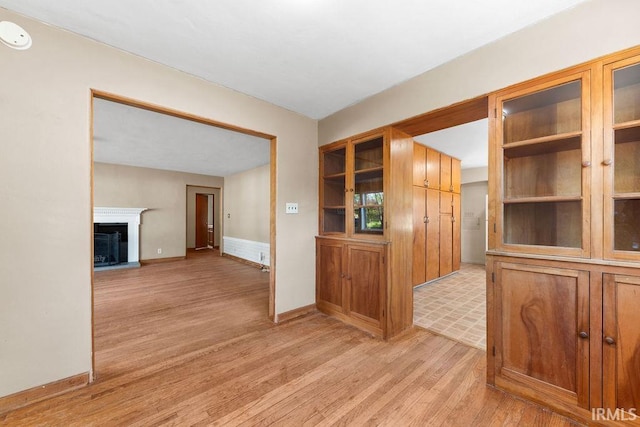 221 S Ironwood Dr, South Bend, IN 46615 - interior space featuring light wood-style flooring, a fireplace with raised hearth, a smoke detector, and baseboards