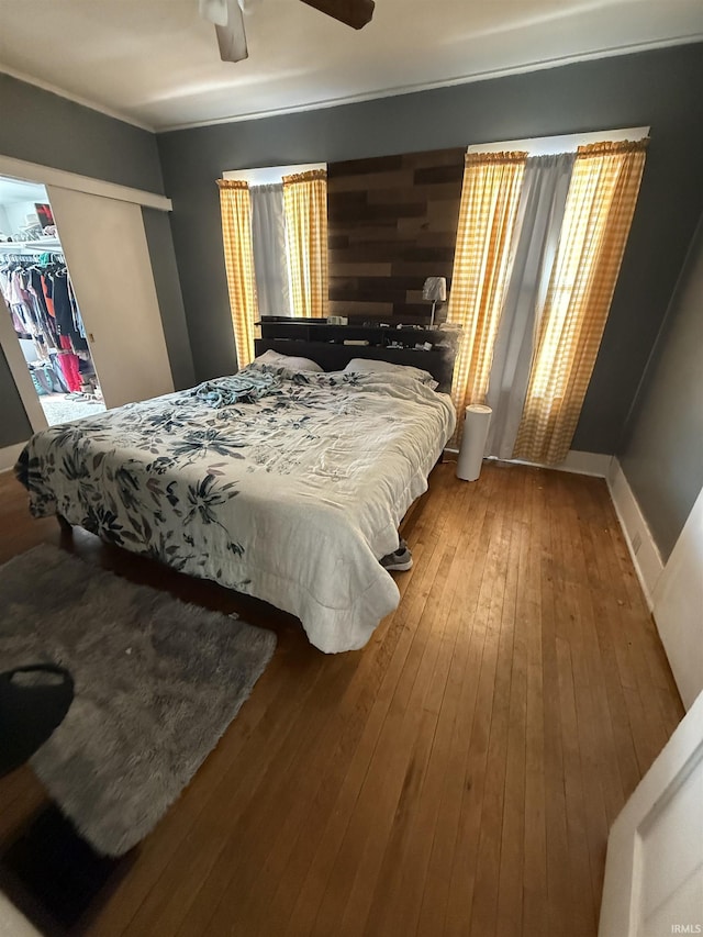255 W Main St, Peru, IN 46970 - bedroom with hardwood / wood-style flooring, a closet, a ceiling fan, and baseboards