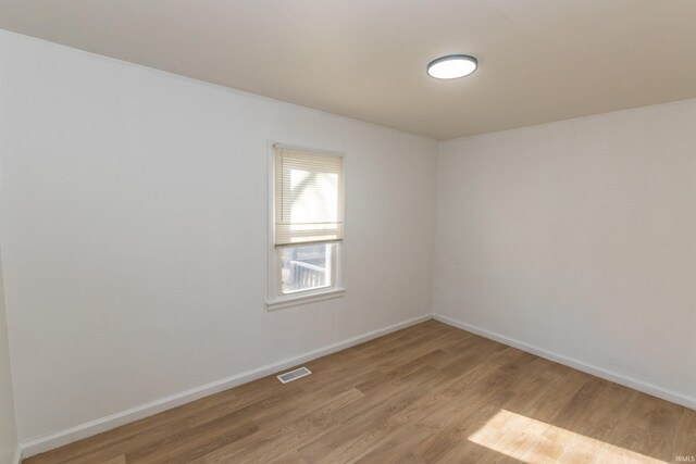 1926 E 17th St, Muncie, IN 47304 - empty room with light wood-style flooring and baseboards