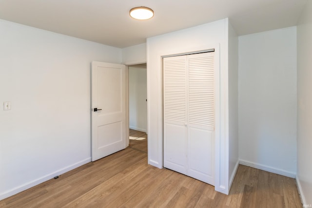 1926 E 17th St, Muncie, IN 47304 - unfurnished bedroom featuring light wood finished floors, a closet, and baseboards
