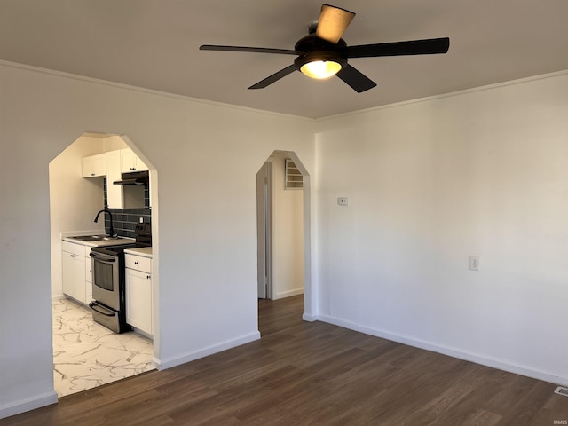 1926 E 17th St, Muncie, IN 47304 - kitchen with electric stove, arched walkways, a ceiling fan, under cabinet range hood, and crown molding