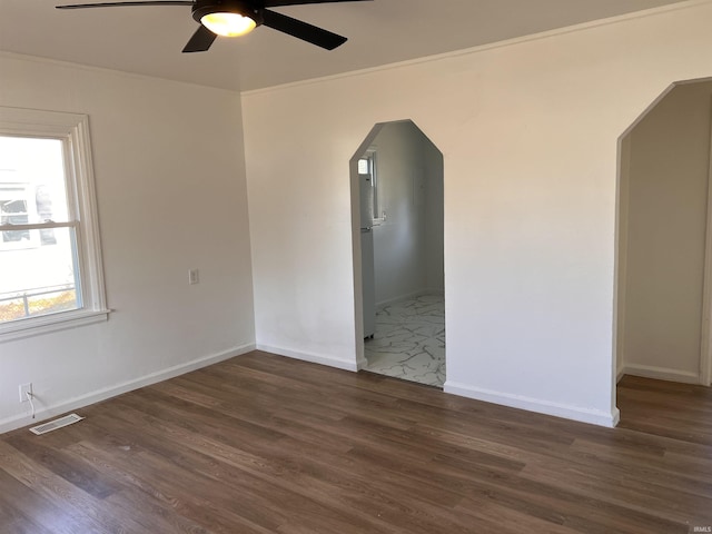 1926 E 17th St, Muncie, IN 47304 - empty room featuring ceiling fan, arched walkways, and wood finished floors