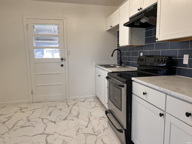 1926 E 17th St, Muncie, IN 47304 - kitchen featuring under cabinet range hood, electric range, a sink, light marble finish flooring, and baseboards