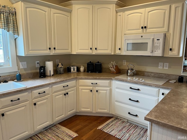 6425 E Wellston Dr, Bloomington, IN 47408 - kitchen featuring white appliances, a sink, dark wood finished floors, and white cabinets