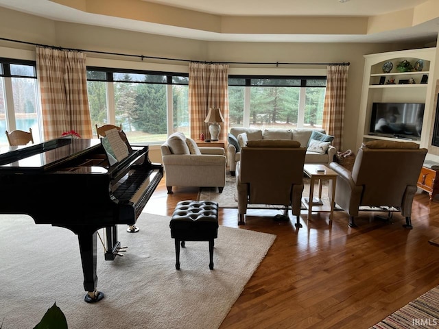 6425 E Wellston Dr, Bloomington, IN 47408 - living room featuring plenty of natural light, a raised ceiling, and wood finished floors
