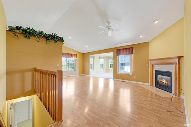 8928 Goshawk Ln, Fort Wayne, IN 46825 - unfurnished living room featuring vaulted ceiling, light wood-type flooring, a tile fireplace, ceiling fan, and recessed lighting