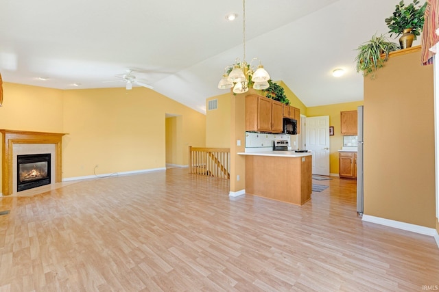 8928 Goshawk Ln, Fort Wayne, IN 46825 - kitchen with open floor plan, vaulted ceiling, black microwave, ceiling fan, and light countertops