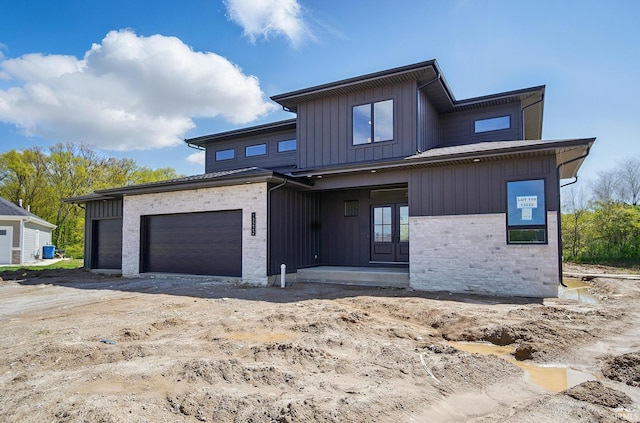 13222 Malfini Trl, Fort Wayne, IN 46845 - modern home featuring a garage, french doors, board and batten siding, and stone siding