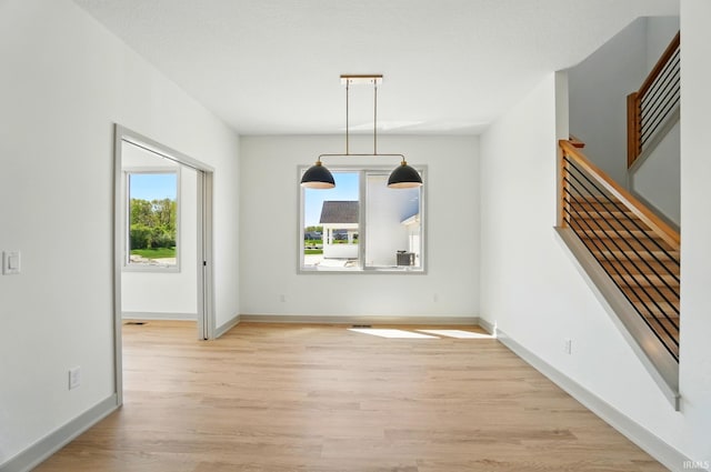 13222 Malfini Trl, Fort Wayne, IN 46845 - unfurnished dining area featuring plenty of natural light, light wood-style flooring, and baseboards