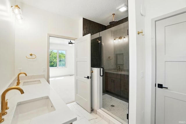 13222 Malfini Trl, Fort Wayne, IN 46845 - full bathroom featuring double vanity, a stall shower, marble finish floors, ceiling fan, and a textured ceiling