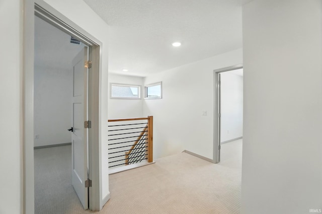 13222 Malfini Trl, Fort Wayne, IN 46845 - hallway with carpet, an upstairs landing, baseboards, and recessed lighting