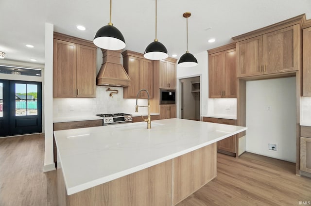 13222 Malfini Trl, Fort Wayne, IN 46845 - kitchen with custom range hood, light wood-style flooring, decorative backsplash, built in microwave, and brown cabinets
