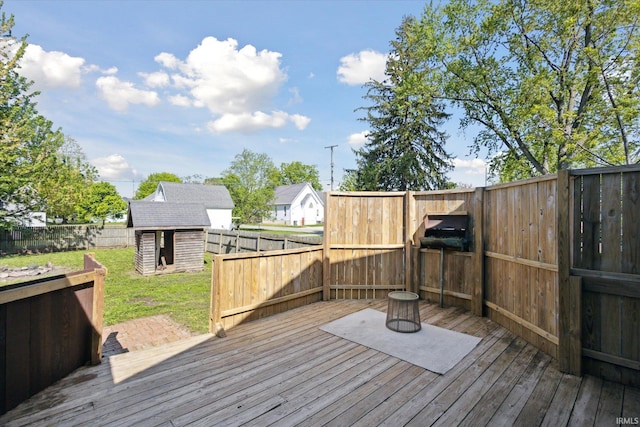 wooden deck with a storage unit and an outdoor structure