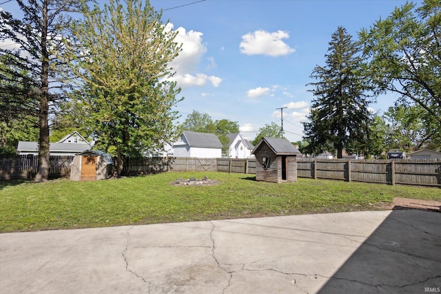 view of yard with a storage shed, a patio, and an outbuilding