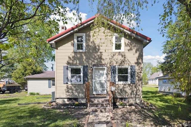 view of front of property with a front lawn and a chimney