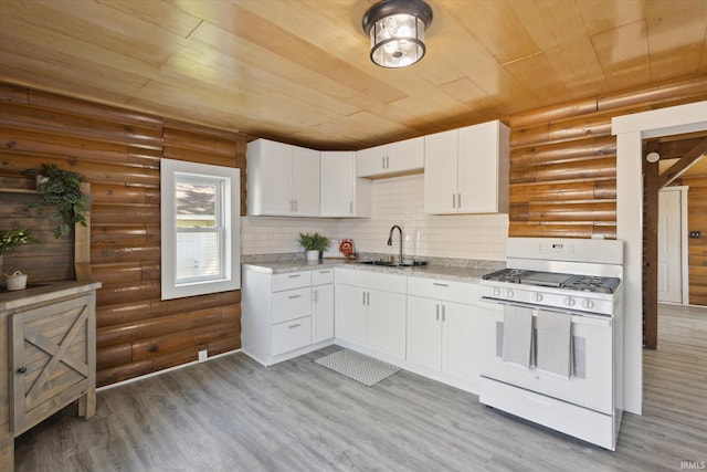 kitchen featuring white range with gas cooktop, wooden ceiling, log walls, a sink, and light wood-style flooring