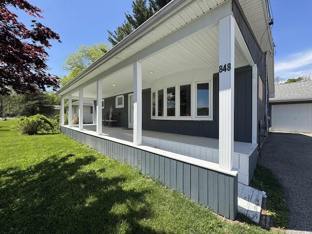 view of home's exterior featuring covered porch and a lawn