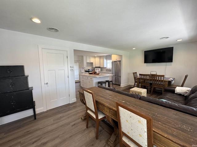 dining room featuring dark wood-style floors, recessed lighting, and baseboards