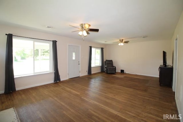 128 E Washington St, Williamsport, IN 47993 - unfurnished living room with ceiling fan, baseboards, and wood finished floors