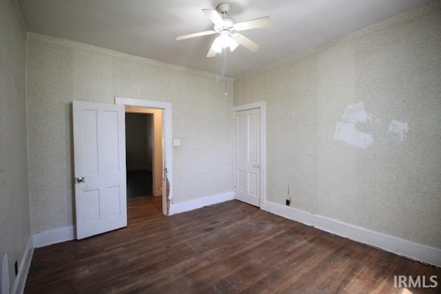 128 E Washington St, Williamsport, IN 47993 - empty room with dark wood-style flooring, a ceiling fan, and baseboards