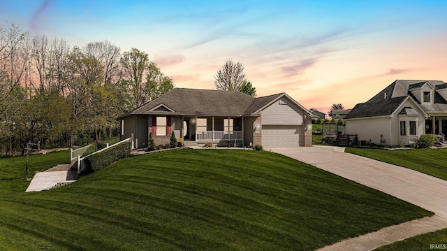 706 Taylor Ln, Albion, IN 46701 - view of front facade featuring a porch, concrete driveway, a lawn, and an attached garage