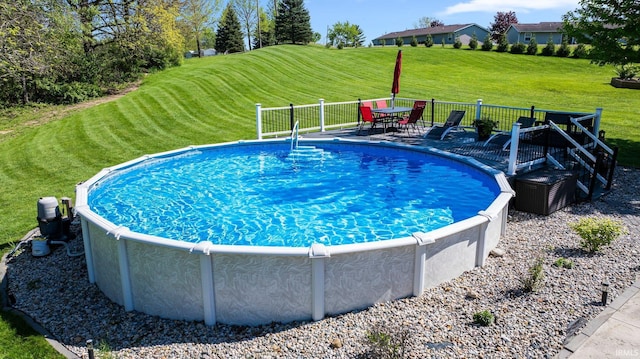 706 Taylor Ln, Albion, IN 46701 - view of swimming pool featuring a yard, a wooden deck, and outdoor dining area