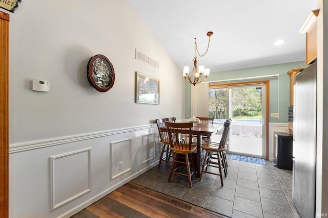 706 Taylor Ln, Albion, IN 46701 - dining room featuring vaulted ceiling, a chandelier, wainscoting, and recessed lighting