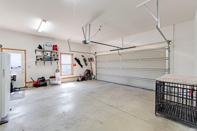 706 Taylor Ln, Albion, IN 46701 - garage with a garage door opener and freestanding refrigerator