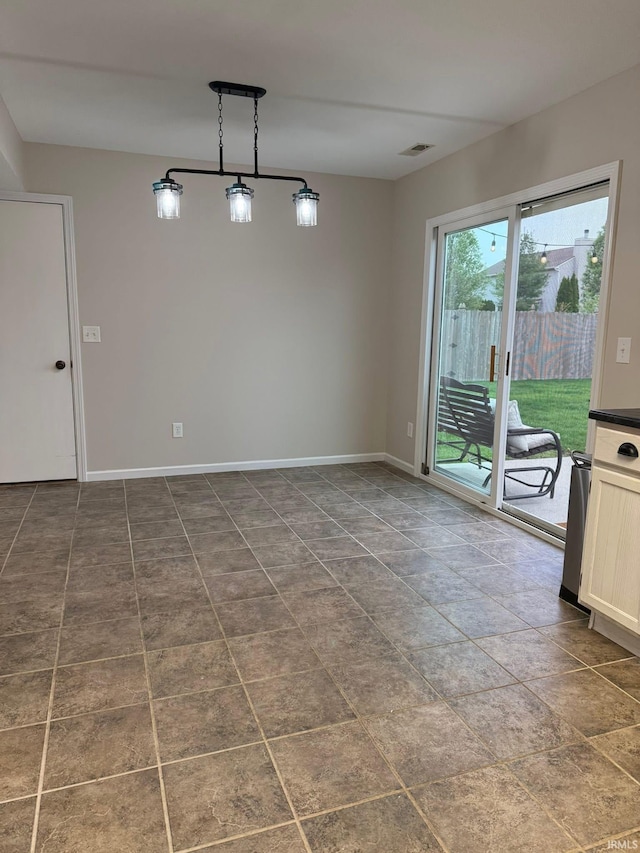unfurnished dining area featuring baseboards