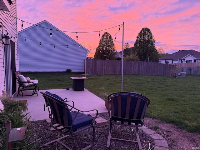yard at dusk featuring a patio