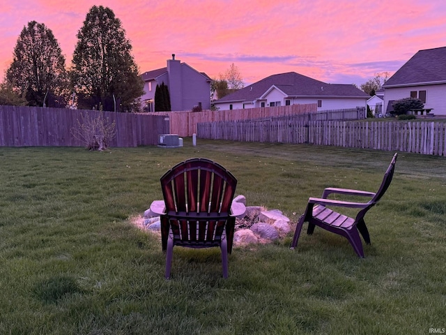 yard at dusk featuring central air condition unit