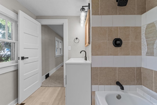 1508 E Hoffer St, Kokomo, IN 46902 - full bathroom featuring wood finished floors, a tub, a tile shower, and vanity