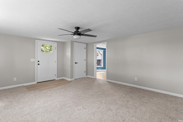 1508 E Hoffer St, Kokomo, IN 46902 - unfurnished room with light carpet, baseboards, ceiling fan, and a textured ceiling