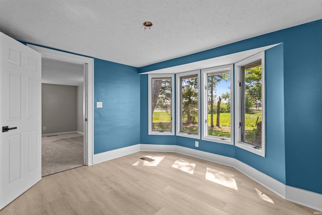 1508 E Hoffer St, Kokomo, IN 46902 - empty room with a textured ceiling, light wood finished floors, and baseboards