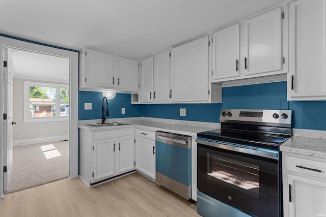 1508 E Hoffer St, Kokomo, IN 46902 - kitchen featuring dishwashing machine, stainless steel electric stove, a sink, light wood-type flooring, and white cabinetry