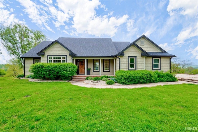 craftsman inspired home featuring a front yard, a porch, and a shingled roof