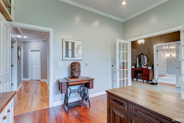 home office featuring crown molding, light wood-style flooring, a chandelier, baseboards, and recessed lighting