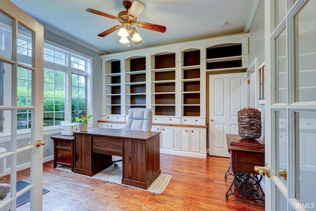 office space with wood finished floors, ceiling fan, ornamental molding, and built in shelves