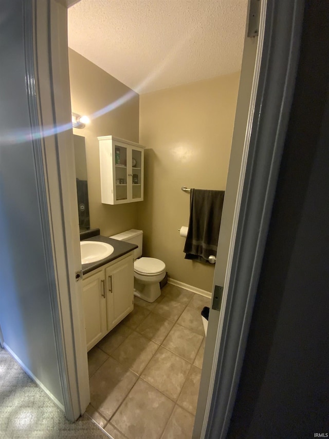 1108 Silver Springs Ct, Fort Wayne, IN 46825 - bathroom with a textured ceiling, vanity, toilet, tile patterned floors, and baseboards