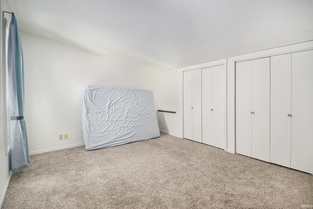 53455 Stoneridge St Unit C, South Bend, IN 46637 - unfurnished bedroom with multiple closets, carpet, and baseboards
