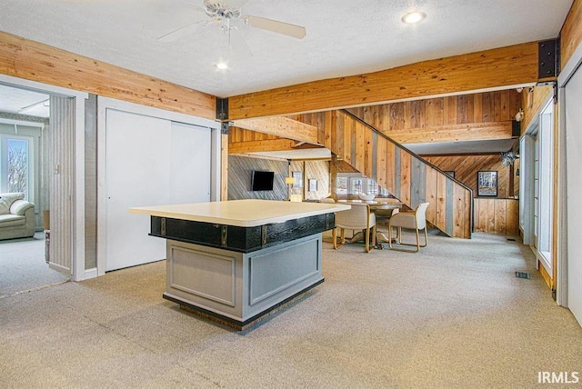 53455 Stoneridge St Unit C, South Bend, IN 46637 - kitchen with wooden walls, open floor plan, light carpet, ceiling fan, and gray cabinets