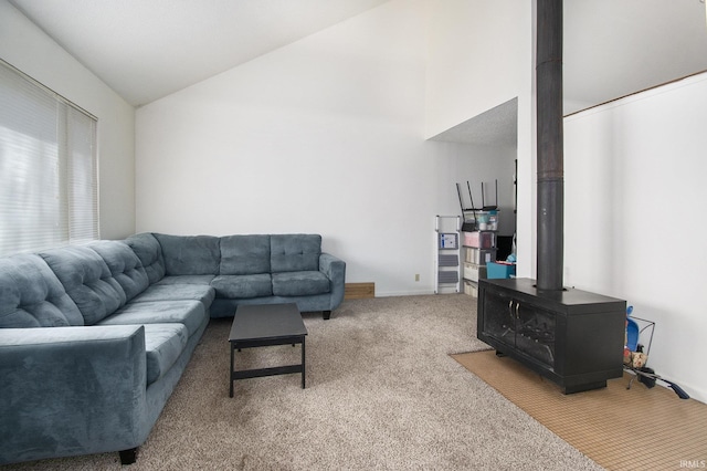 53455 Stoneridge St Unit C, South Bend, IN 46637 - living room with a wood stove, carpet floors, and high vaulted ceiling
