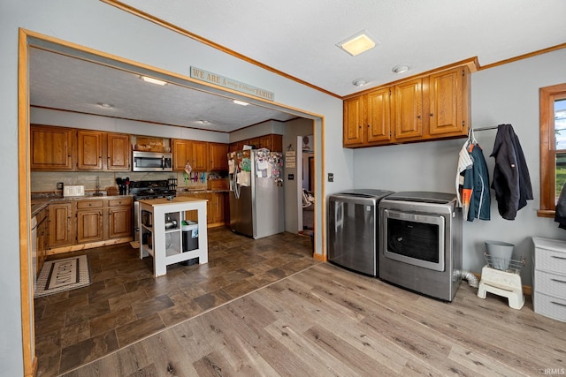 47 E Center St, Williamsport, IN 47993 - laundry area featuring washer and dryer and crown molding