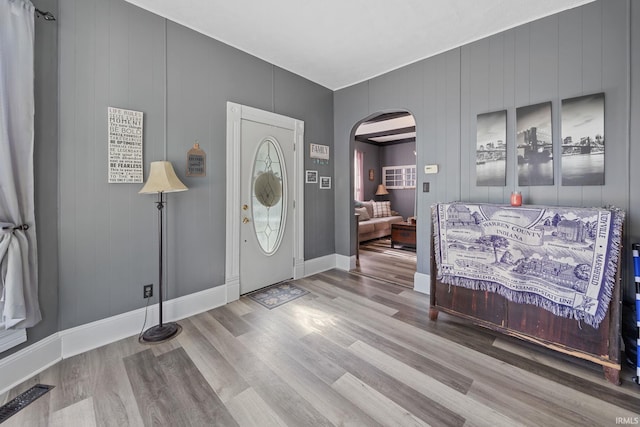 47 E Center St, Williamsport, IN 47993 - foyer entrance with arched walkways, wood finished floors, and baseboards