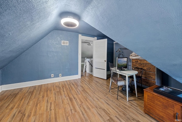 47 E Center St, Williamsport, IN 47993 - bonus room with a textured ceiling, vaulted ceiling, baseboards, and wood finished floors