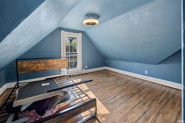 47 E Center St, Williamsport, IN 47993 - bonus room featuring vaulted ceiling, baseboards, wood finished floors, and a textured ceiling
