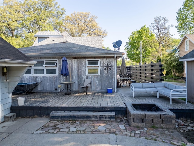 47 E Center St, Williamsport, IN 47993 - rear view of house with a wooden deck, a shingled roof, an outdoor living space with a fire pit, and fence